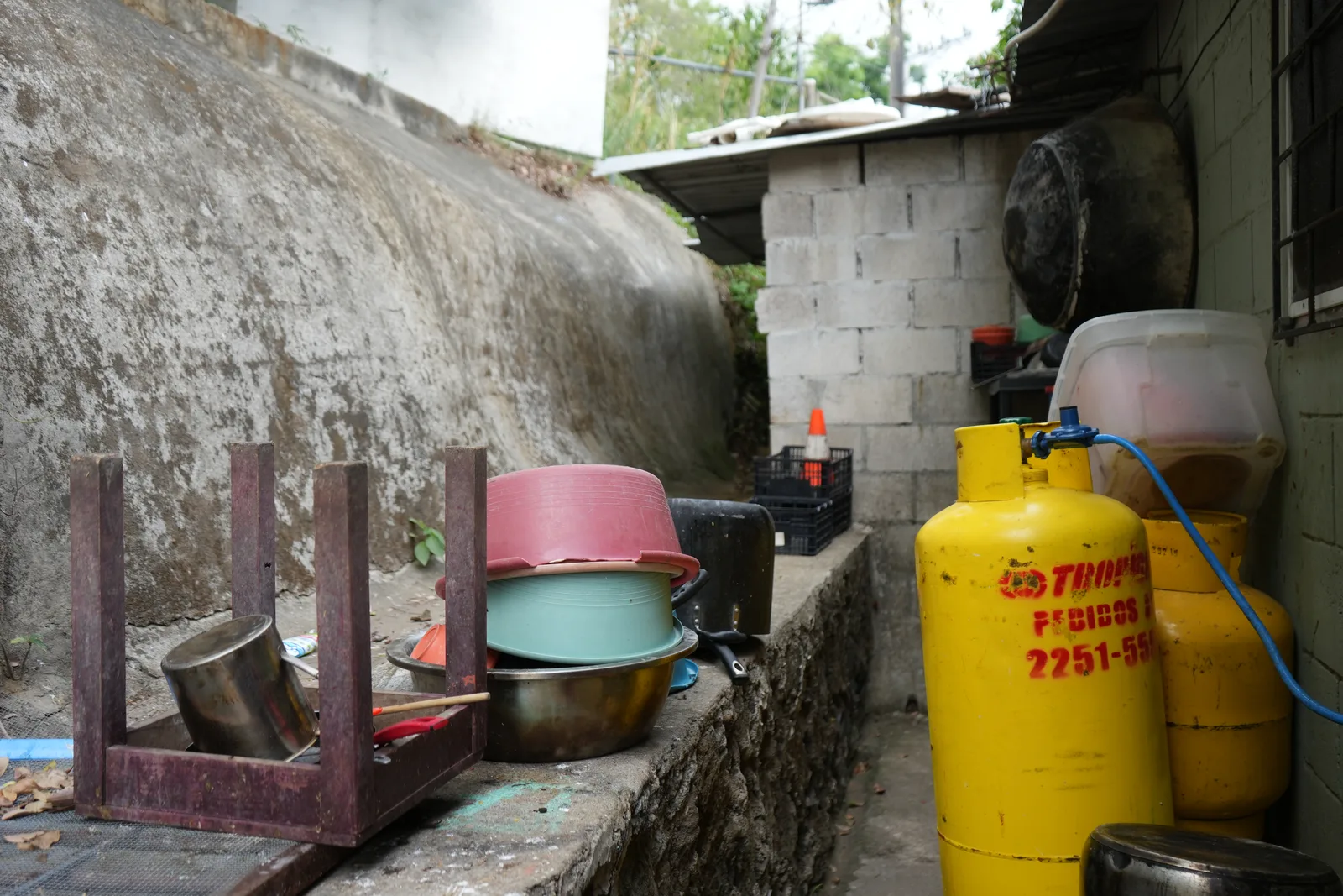 Plastic basins and buckets used in place of running water at the home.