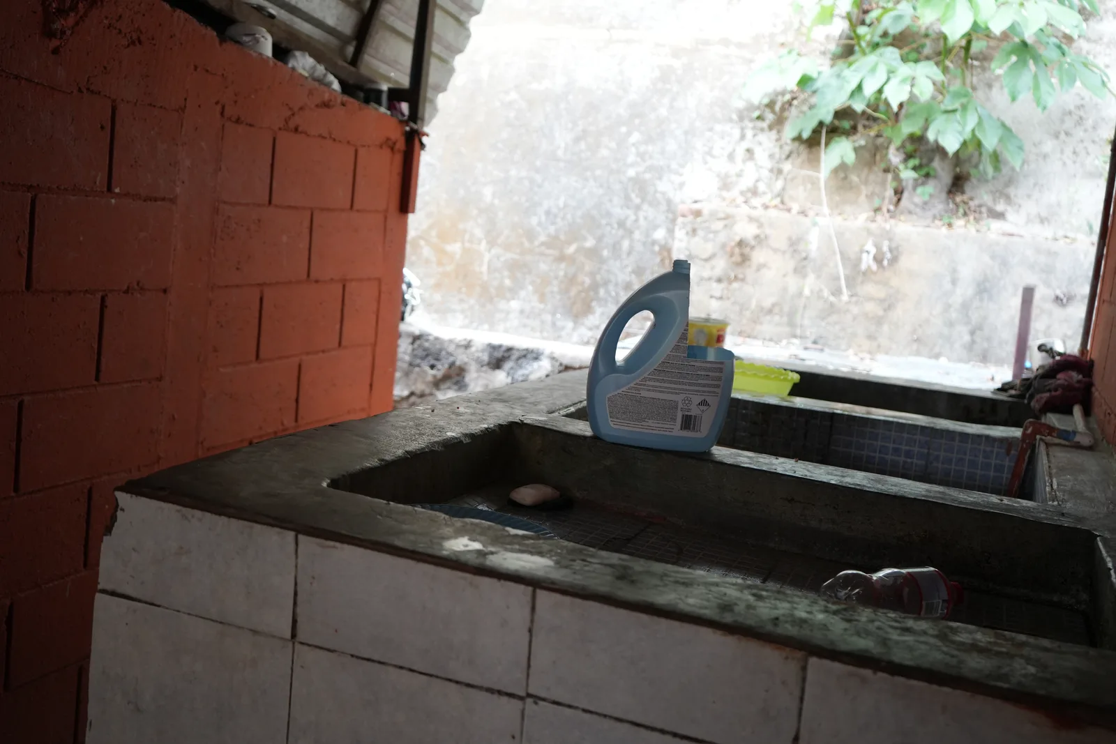The home's main concrete water reservoir (pila) sitting empty.
