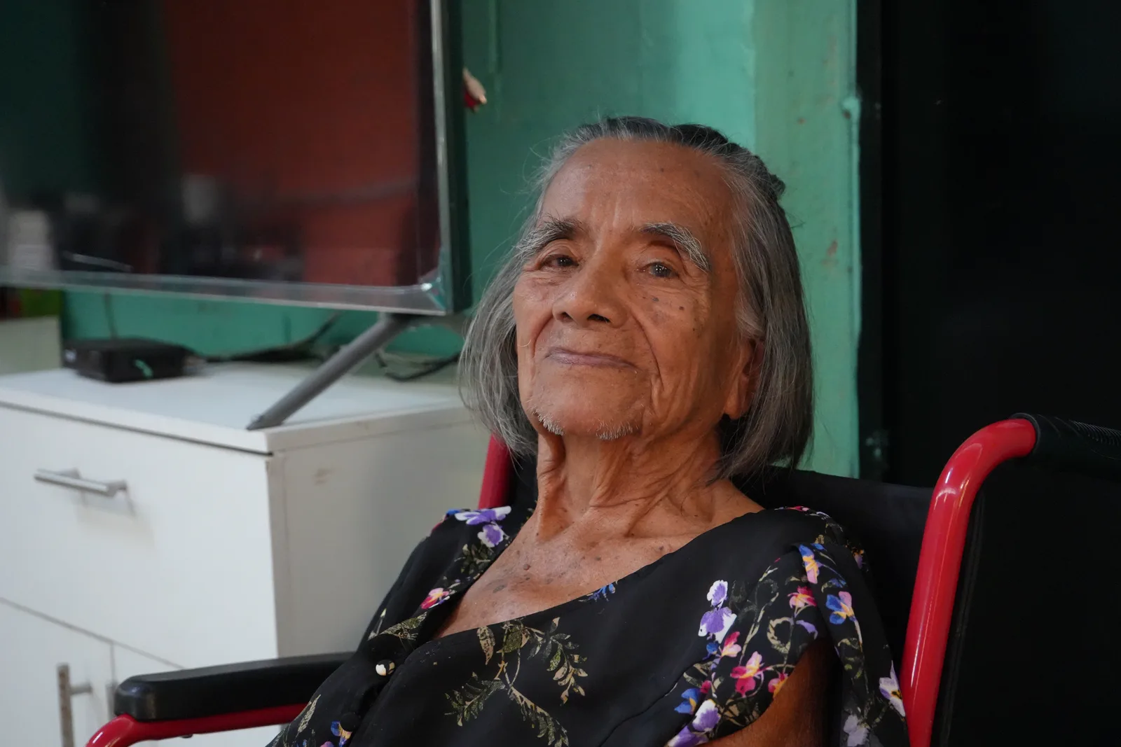 Marta Julia, a resident, in a wheelchair.
