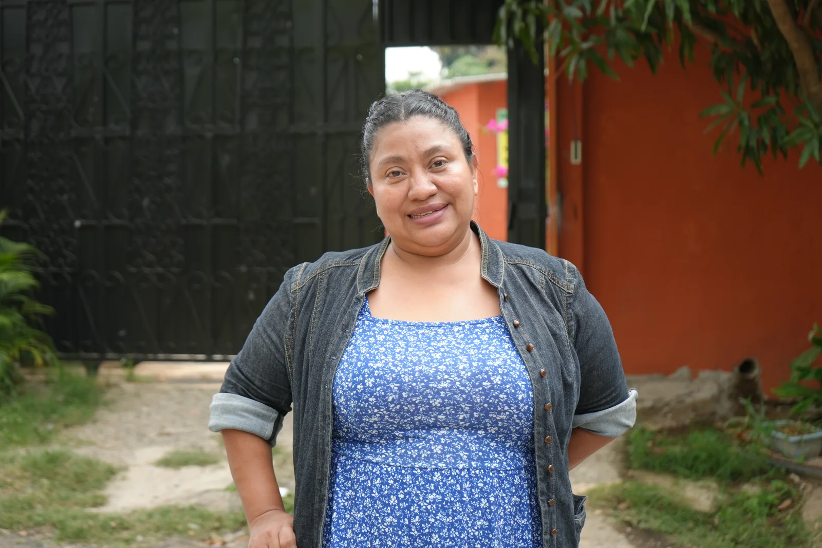 Carolina, General Director of the home, smiling at the entrance gate.